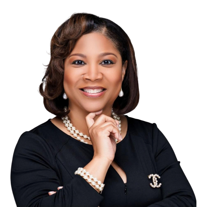 Courtney Johnson Rose smiling in a black blazer with pearl jewelry, posed against a white background