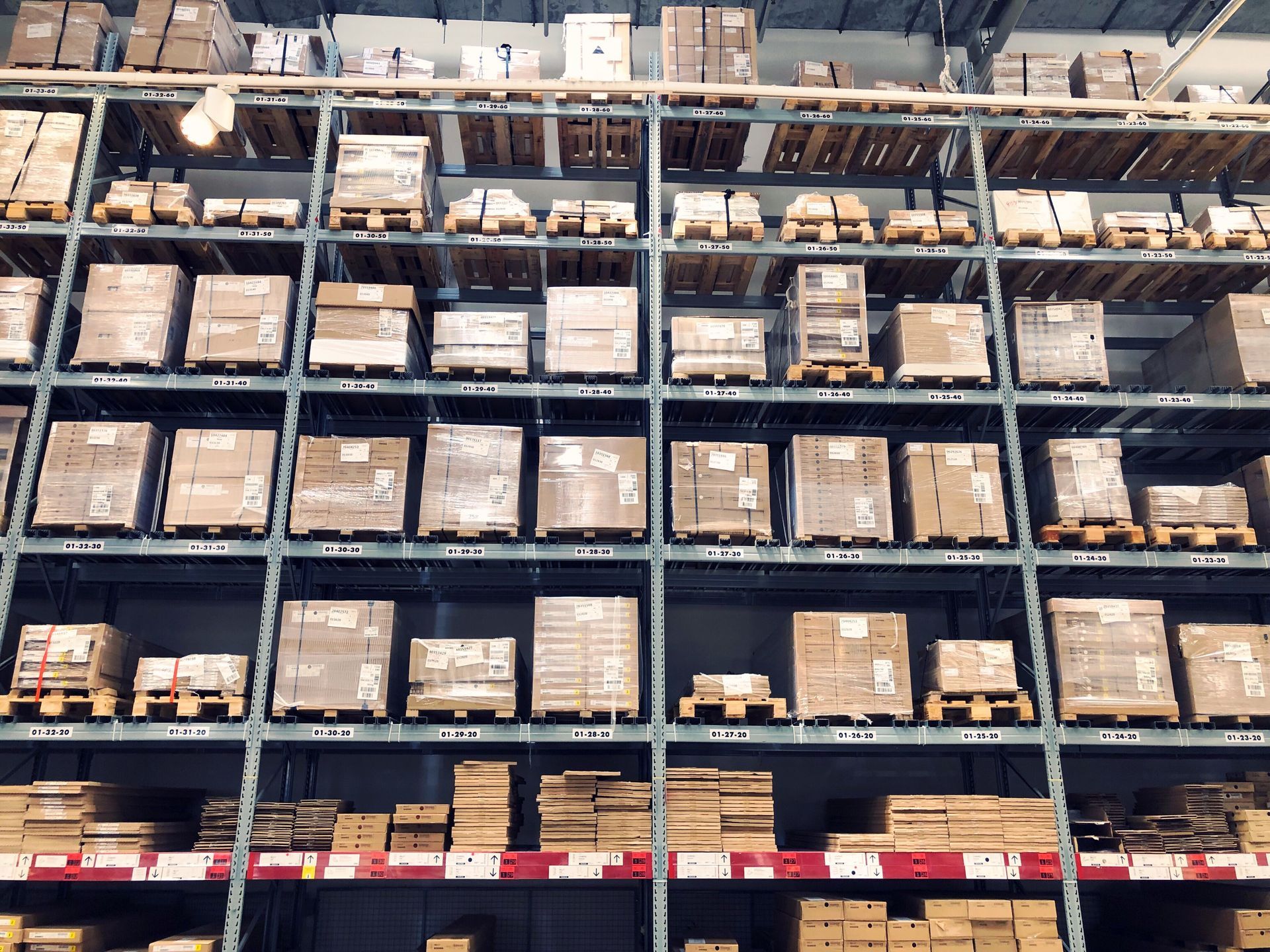 A large warehouse filled with lots of boxes and pallets.