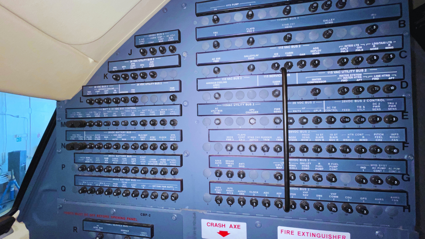 A cockpit of an airplane with a lot of buttons on it