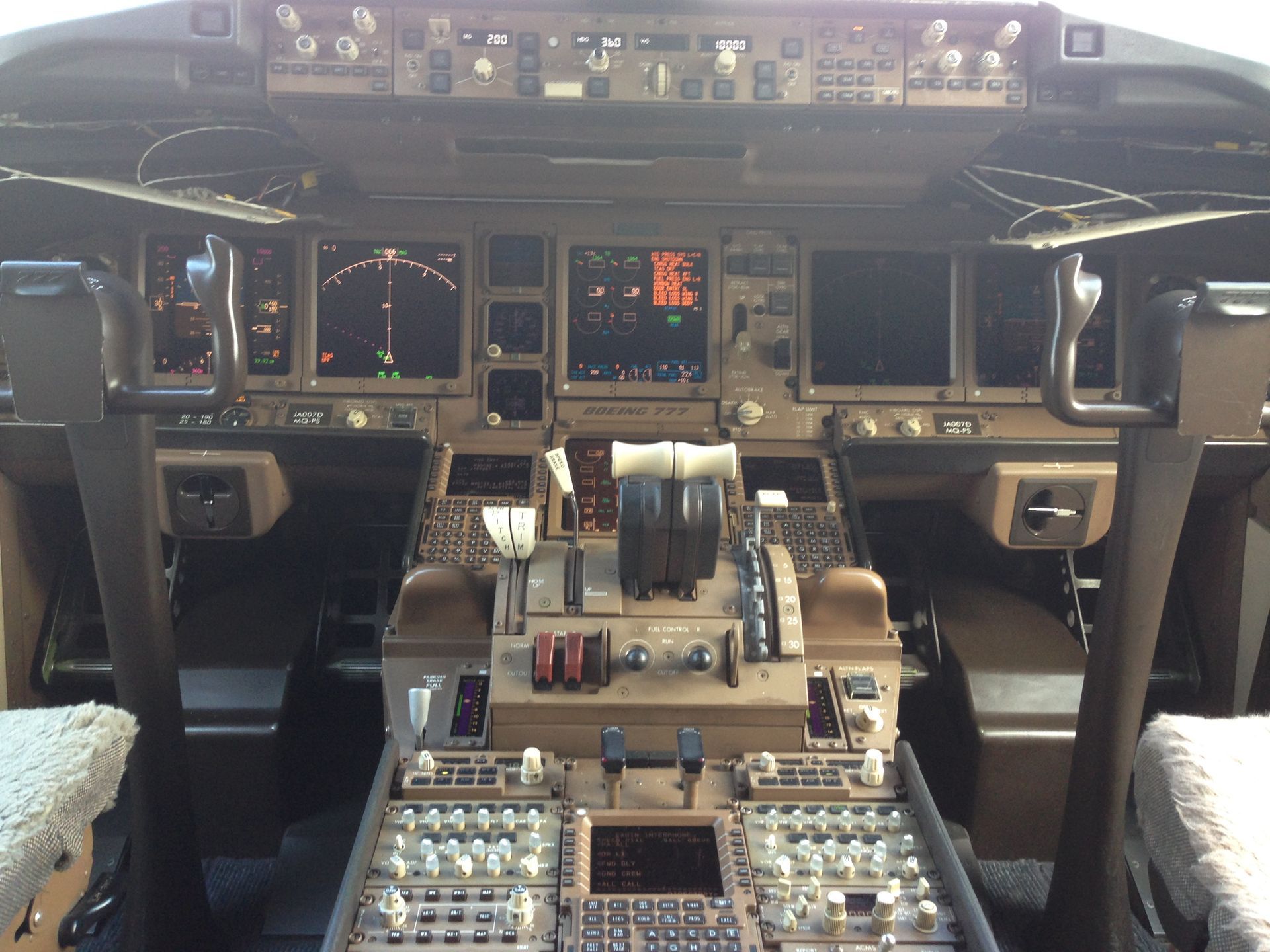 A cockpit of an airplane with a monitor that says r on it