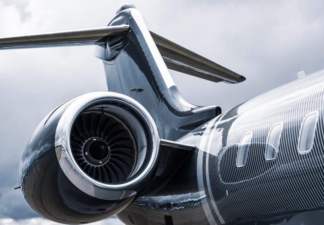 A close up of the rear end of an airplane with a cloudy sky in the background.