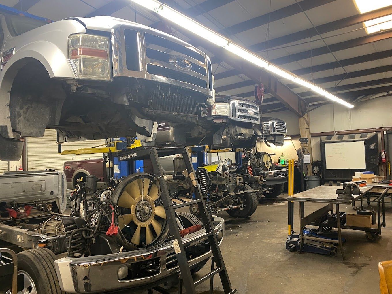 a truck is being worked on in a garage .