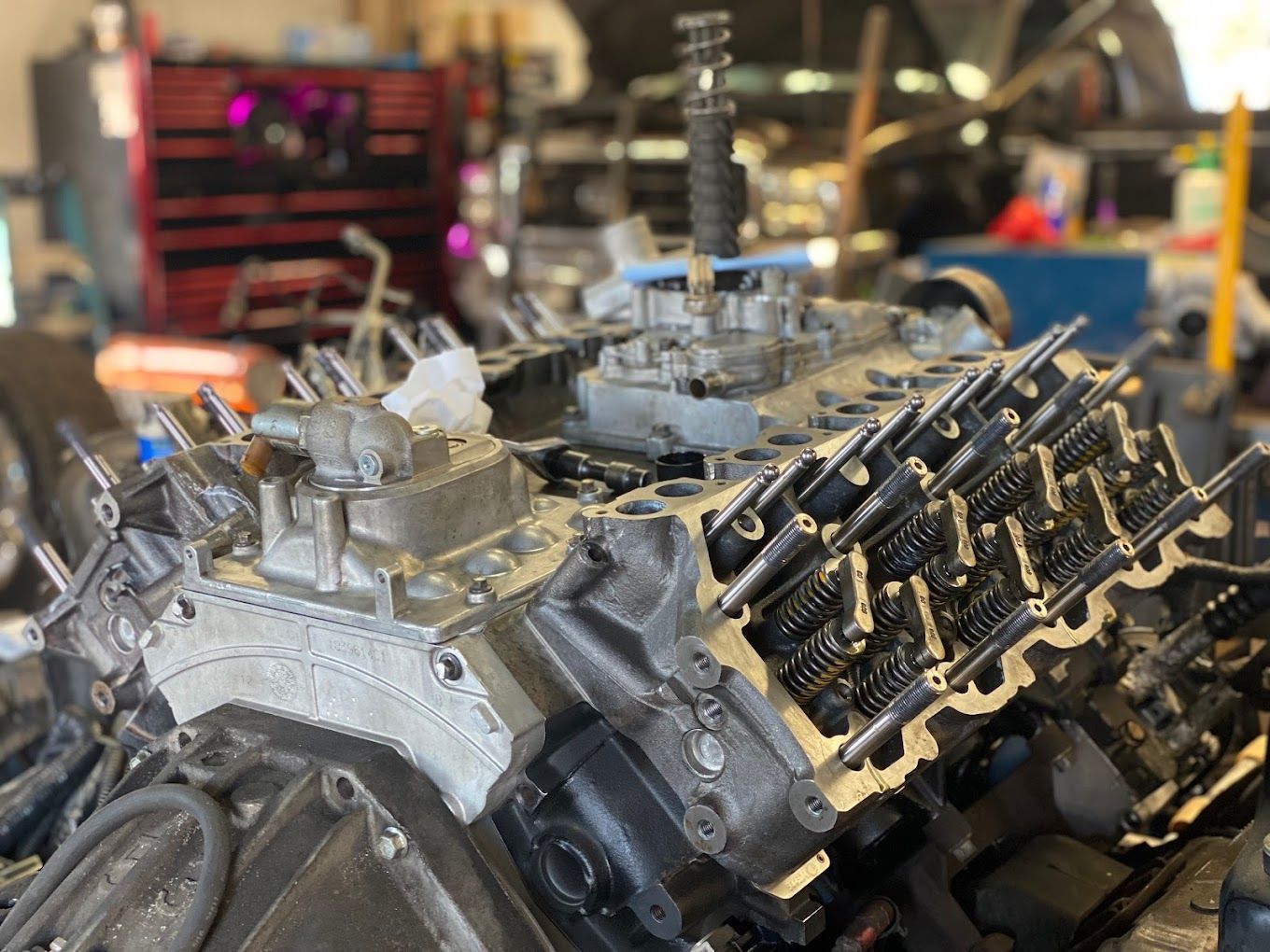 a large engine is sitting on top of a table in a garage .