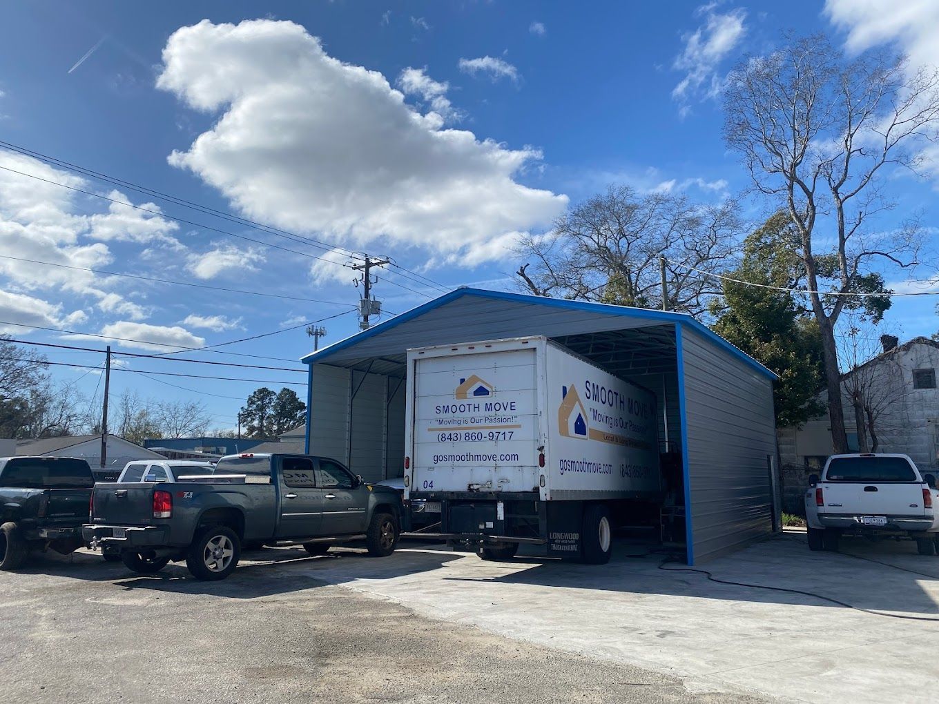 a white truck is parked in front of a metal building .