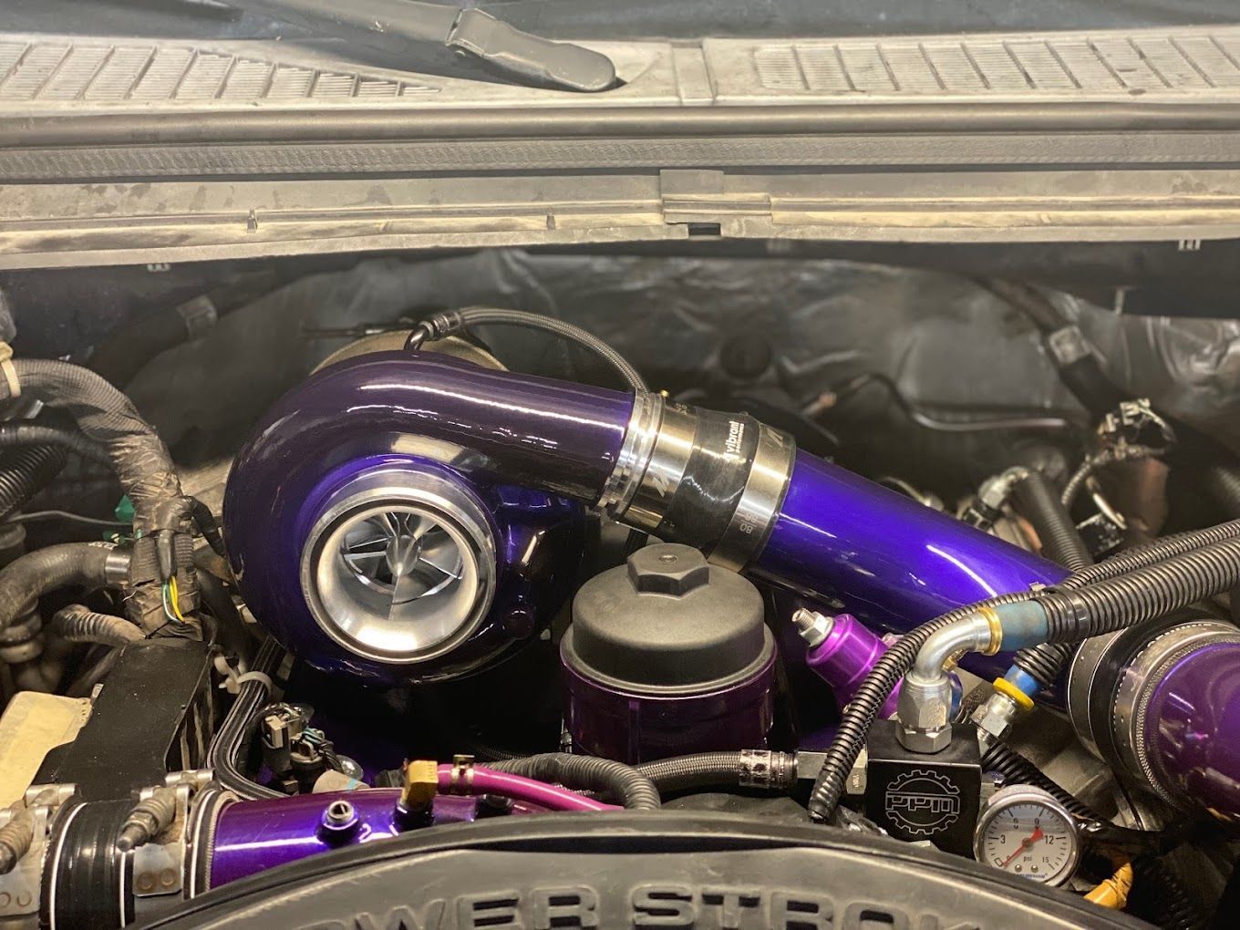 a close up of a car engine with a purple turbocharger .