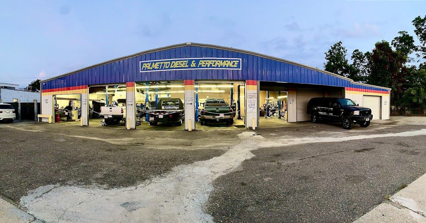 a car dealership with a lot of cars parked in front of it .