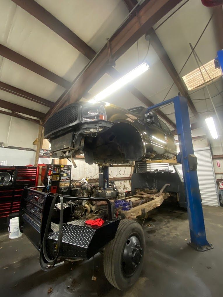 a car is sitting on a lift in a garage .