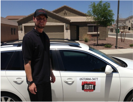 A man standing in front of a white car that says elite appliance repair