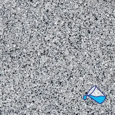 A close up of a gray granite counter top with a pitcher of water pouring out of it.