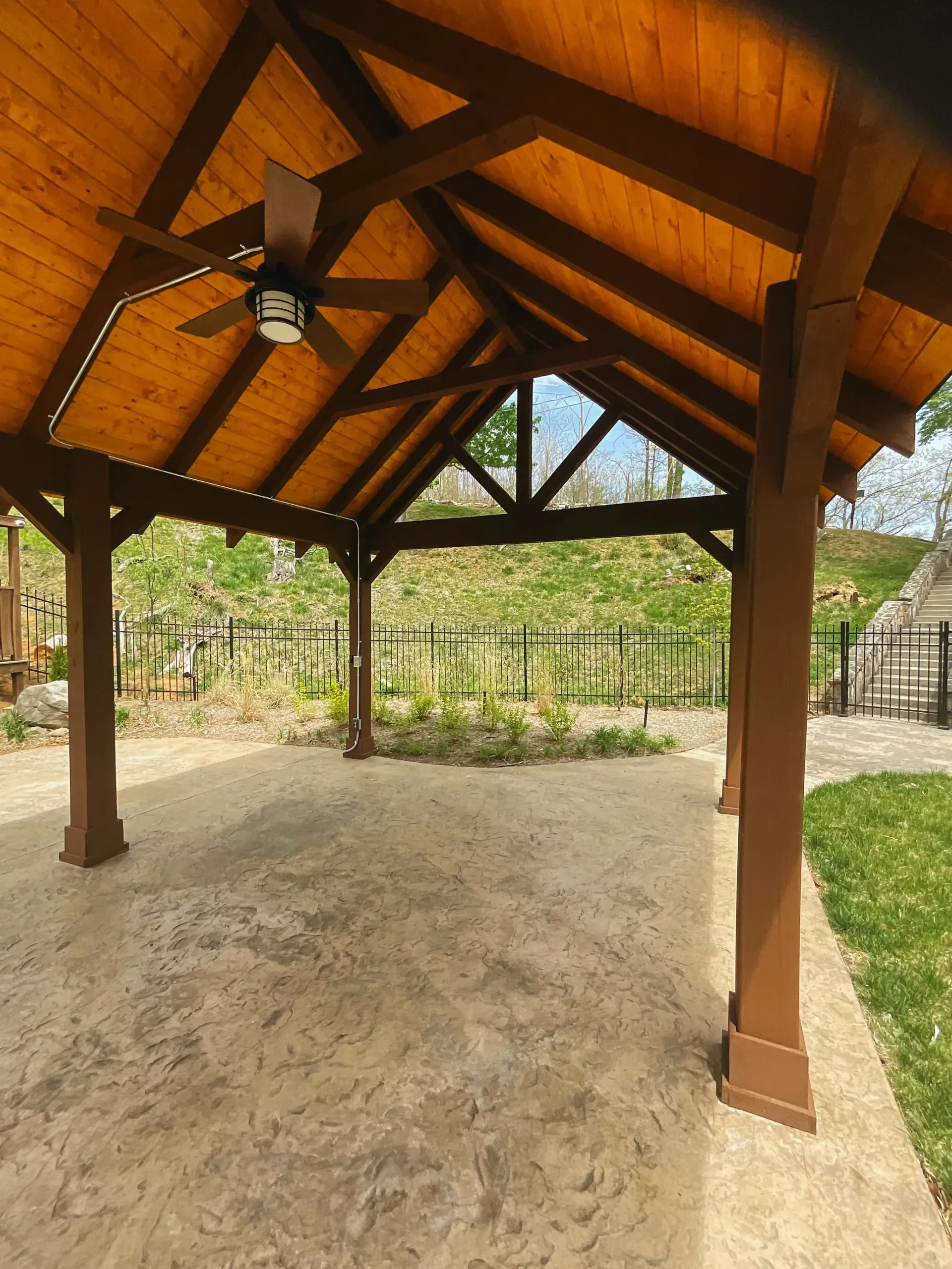 Custom timber-framed pavilion with vaulted ceiling and stamped concrete flooring,