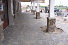 A brick walkway with pillars in the middle of it