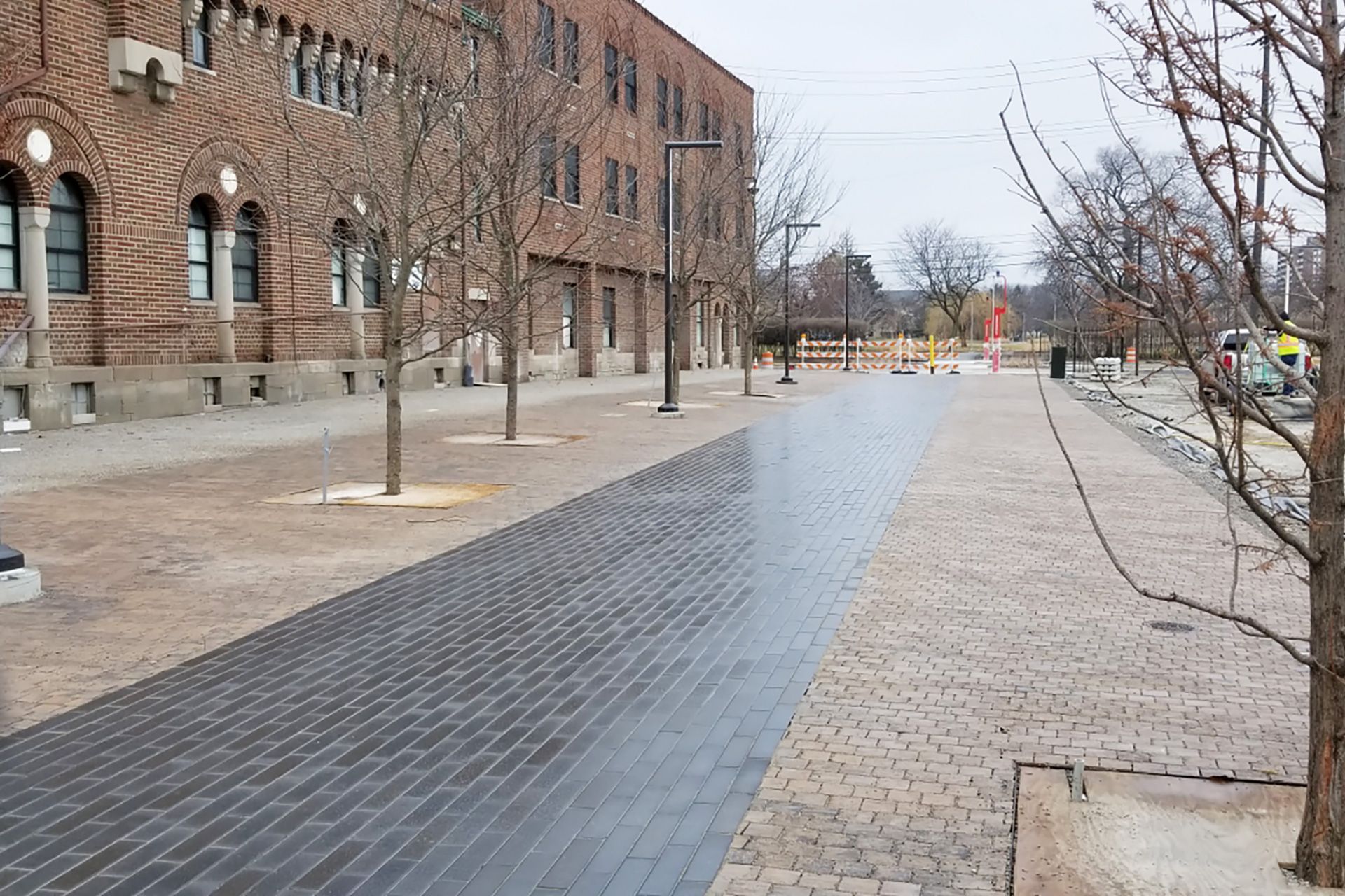 A brick building with a brick walkway in front of it