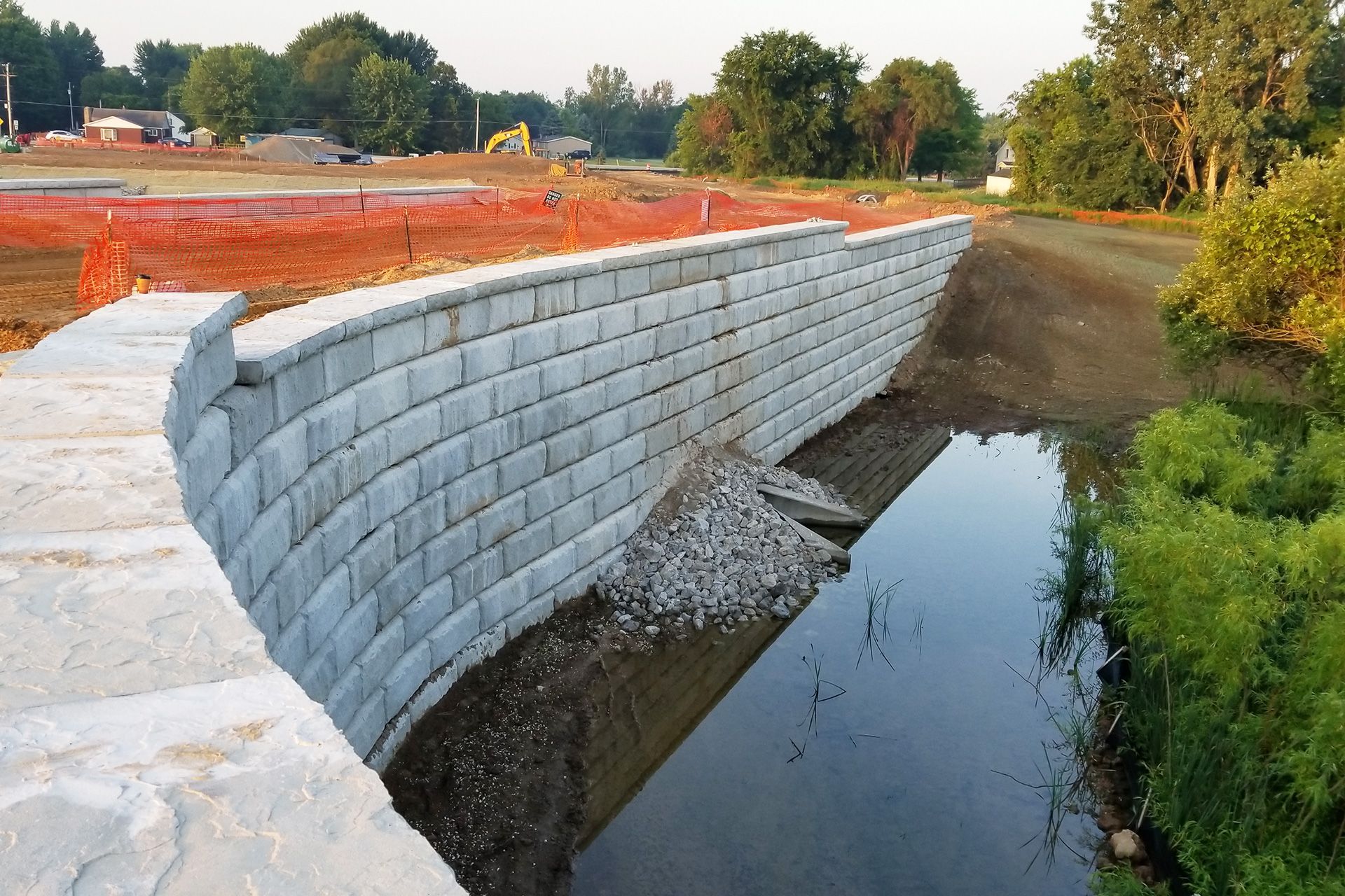 A brick wall along the side of a river