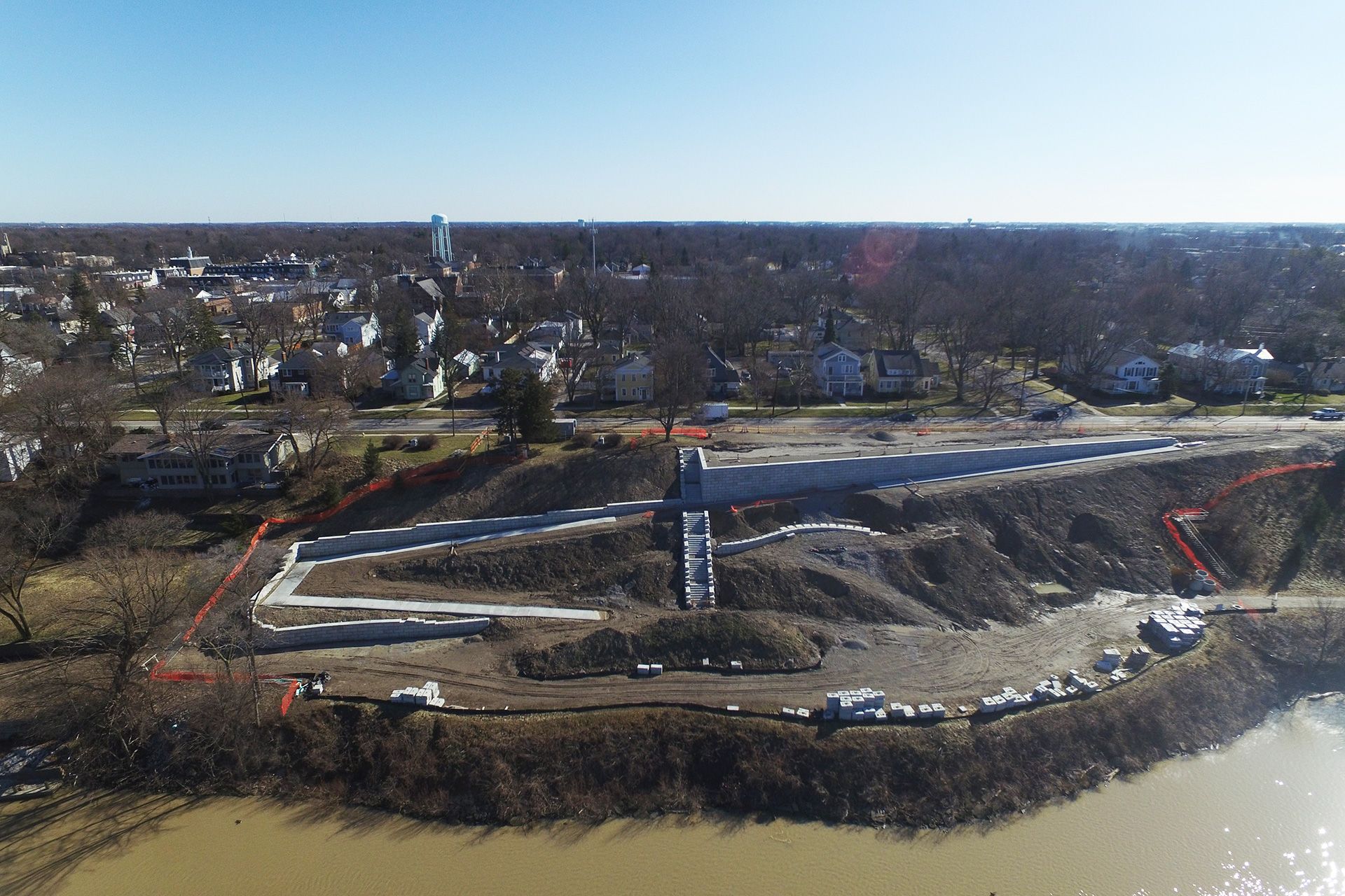 An aerial view of a construction site next to a river.