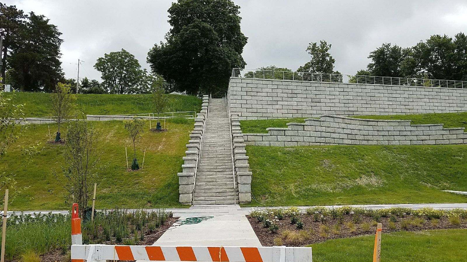 A staircase is going up a grassy hill in a park.