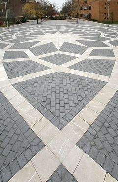 A large brick pavement with a geometric pattern on it