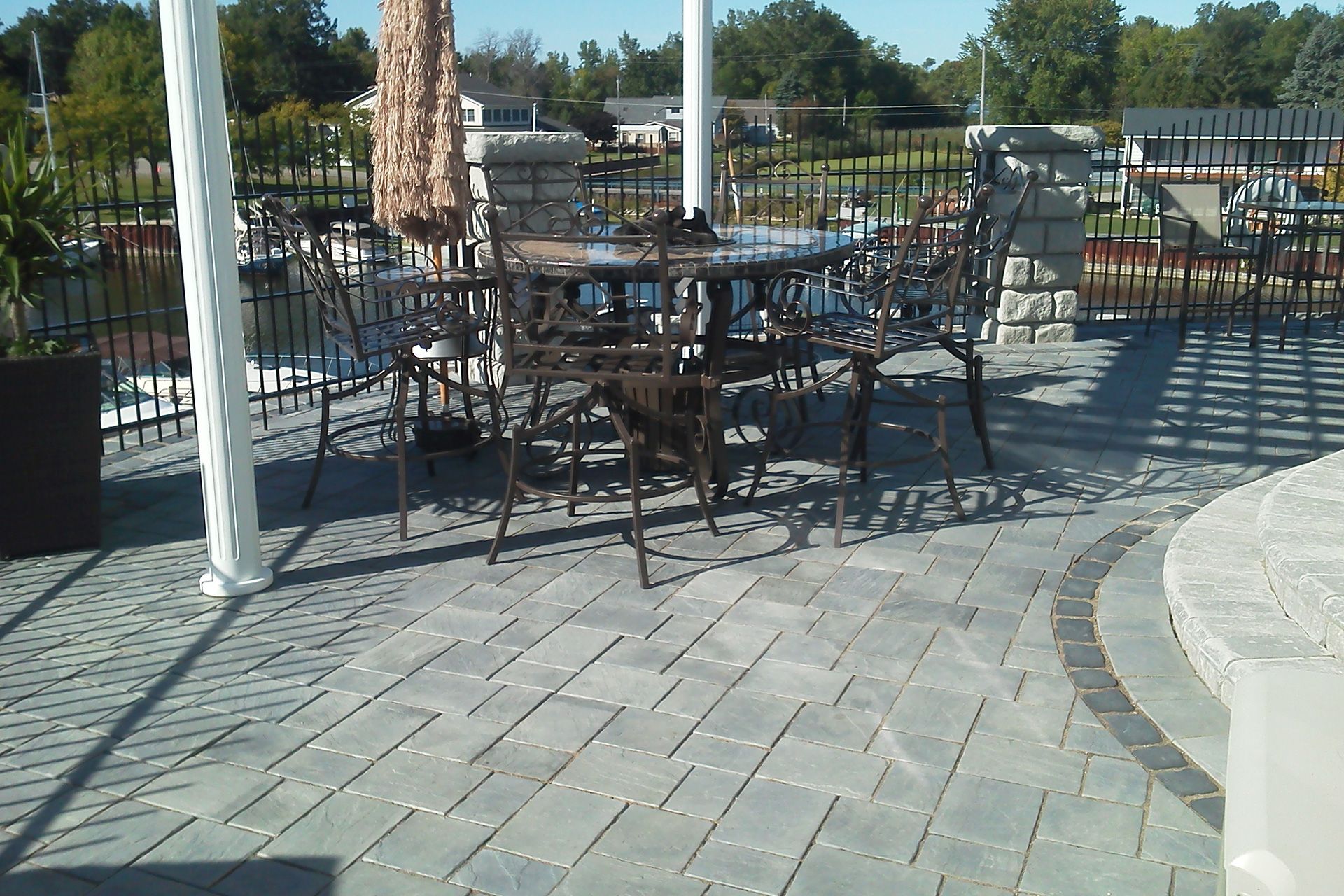 A patio with a table and chairs and an umbrella