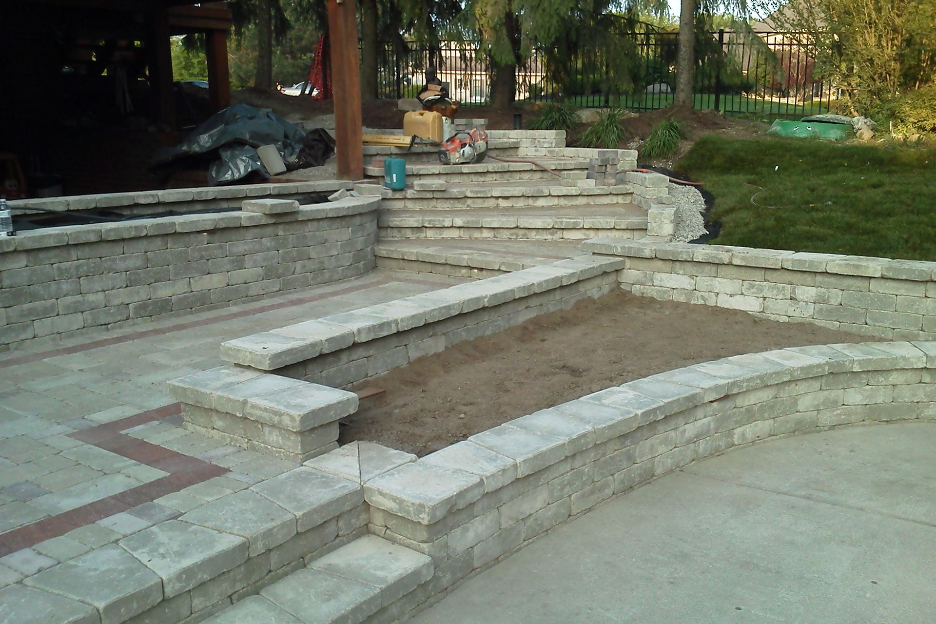 A patio with stairs and a brick wall