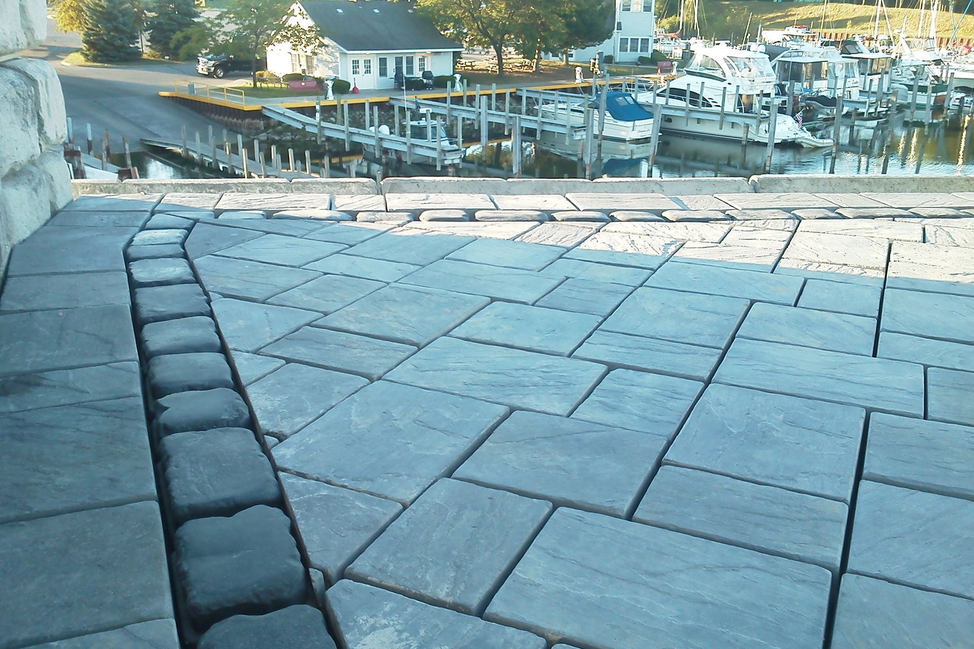 A patio with a view of a marina with boats docked