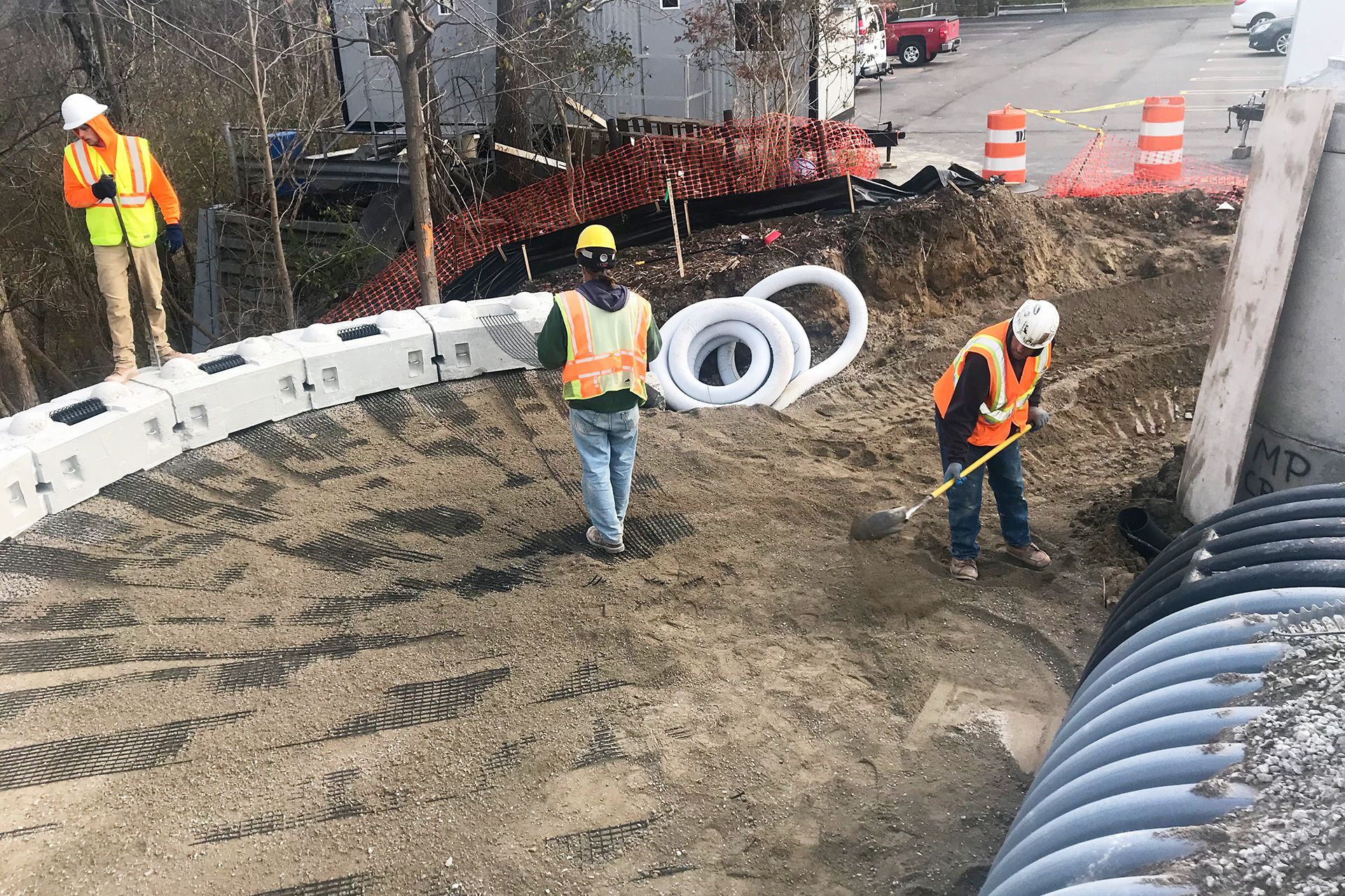 A group of construction workers are working on a road.
