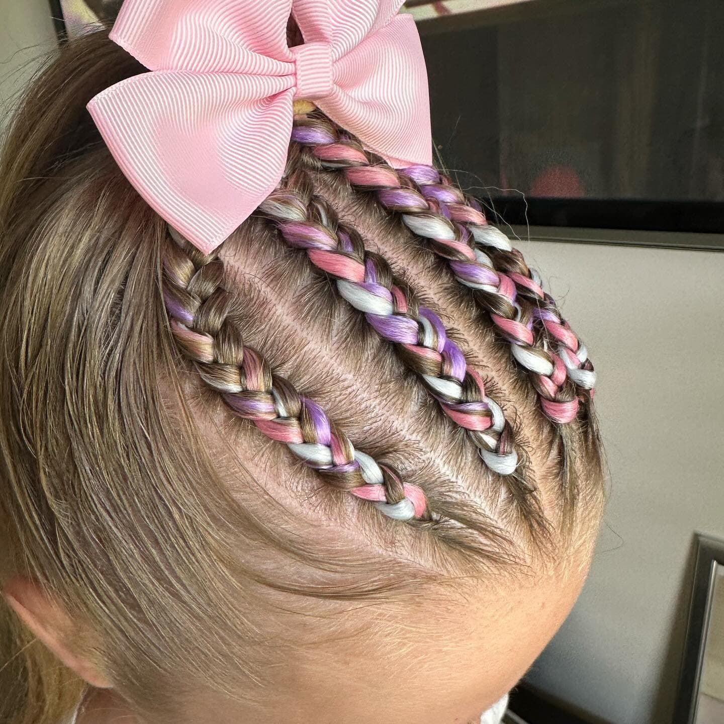 A Close-up Of A Hairstyle Featuring Three Tight Cornrow Braids — Sweet Parties & Braids in Tatton, NSW
