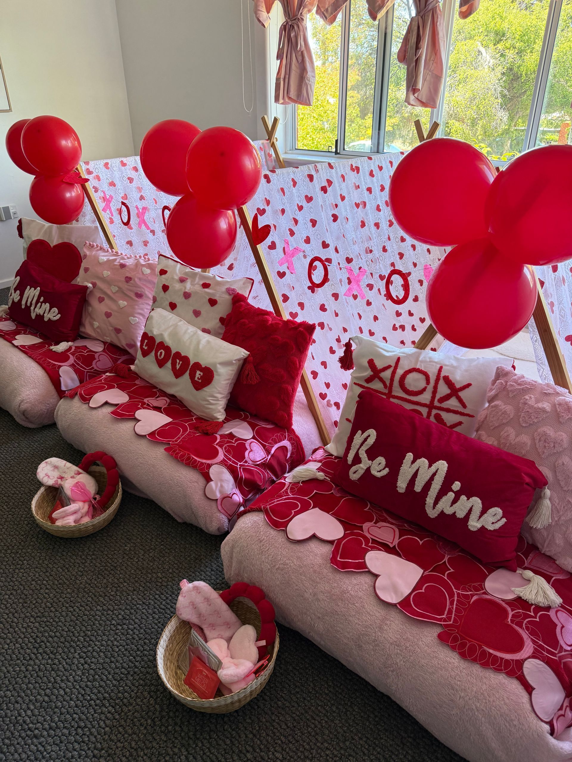 Red Valentine’s Day Couch With Heart Balloons, Pillows, and Gift Baskets — Sweet Parties & Braids in Tatton, NSW