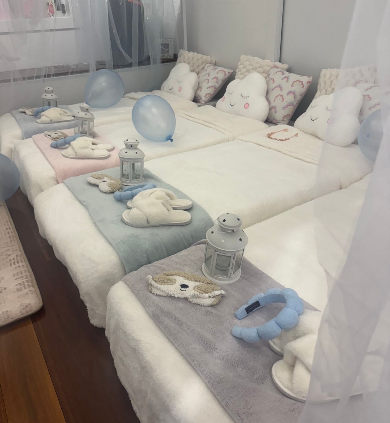 Bedroom With a White Bed, Pastel Pillows, Sheer Canopy, and Baby Toys — Sweet Parties & Braids in Tatton, NSW