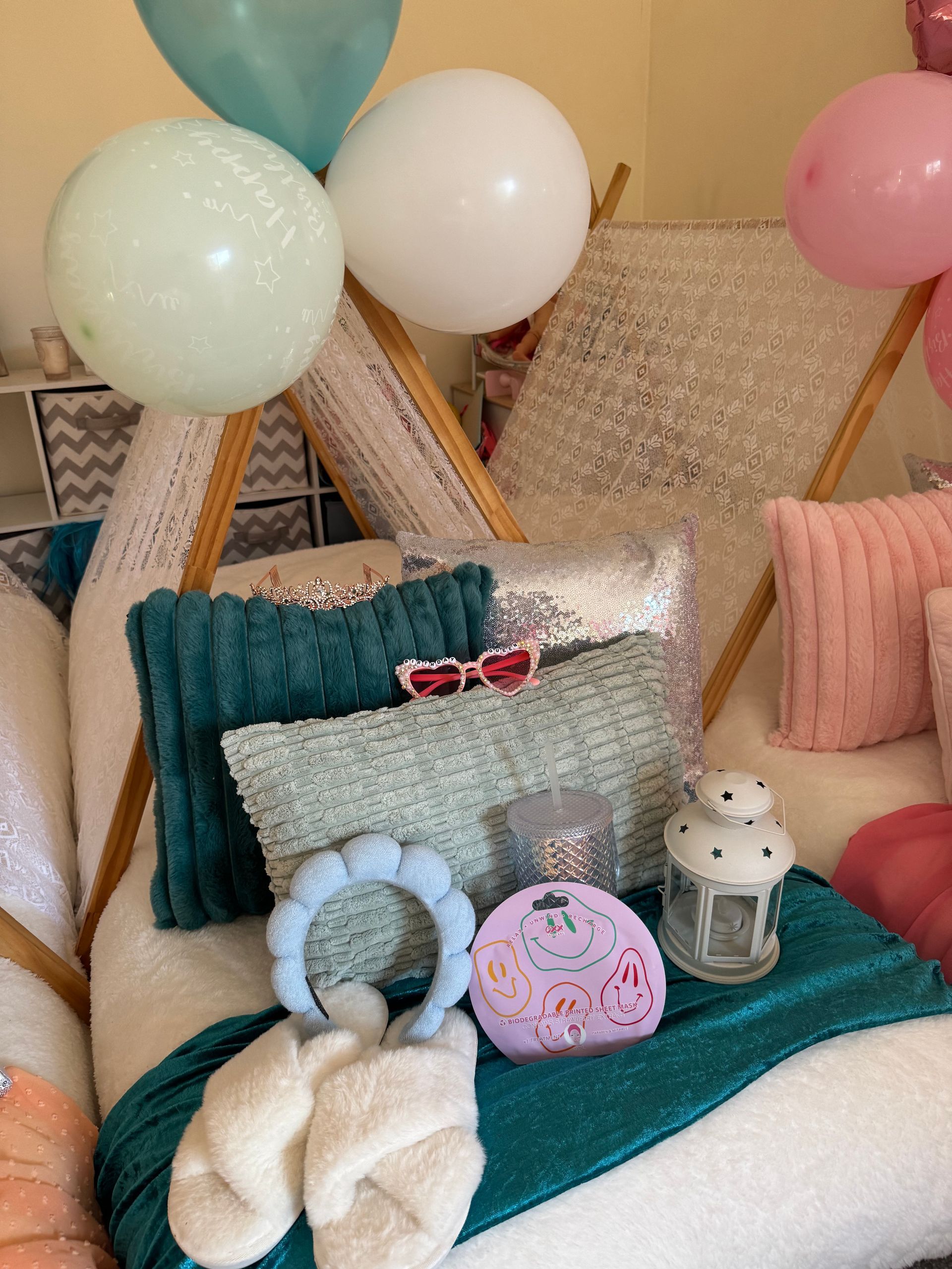 Pastel balloons and cushions on a teal rug with party decor and lanterns — Sweet Parties & Braids in Tatton, NSW