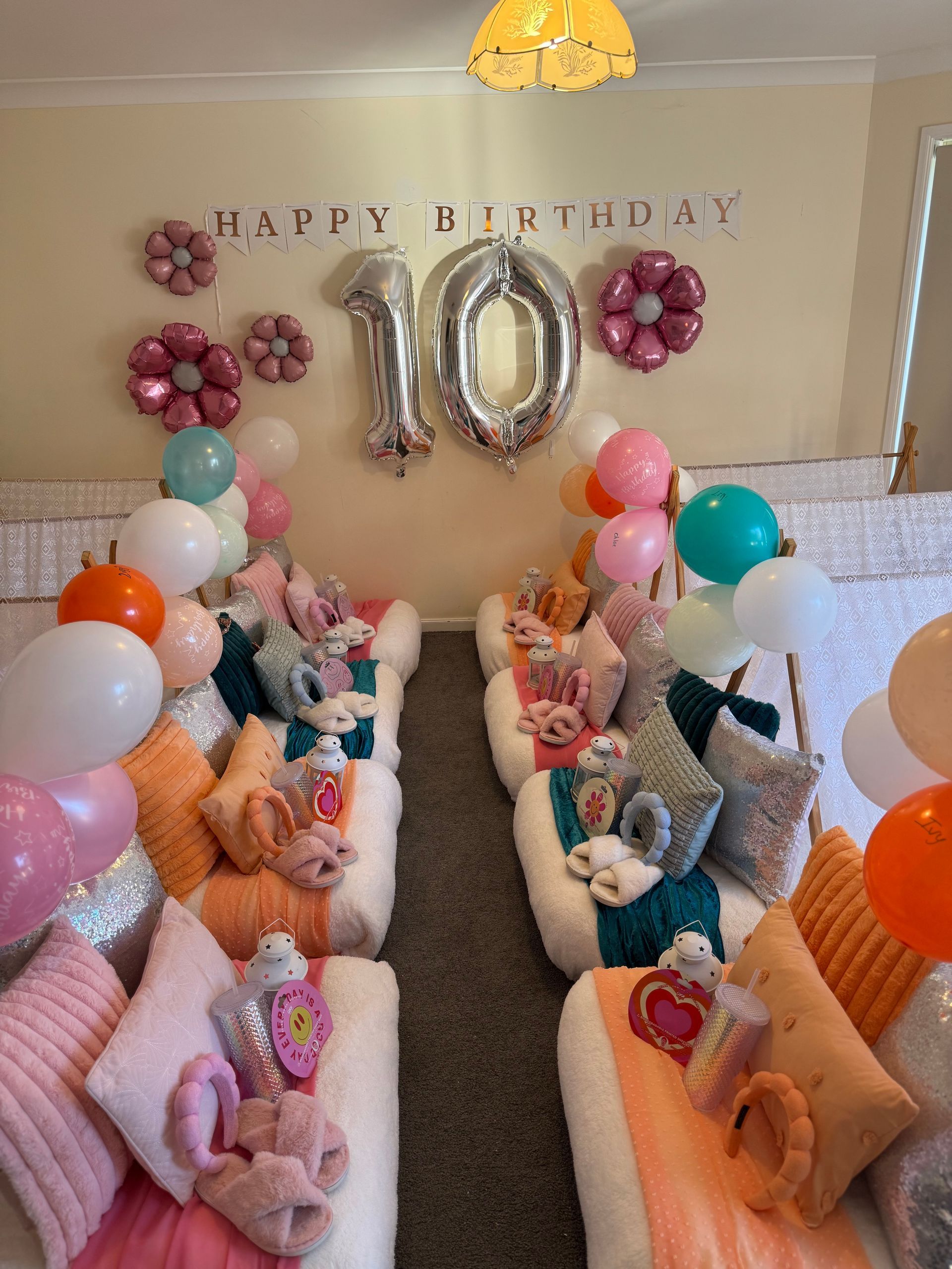 Birthday party setup with “Happy Birthday 10” balloons, pastel decor, and two rows of seating with teddy bears. — Sweet Parties & Braids in Tatton, NSW