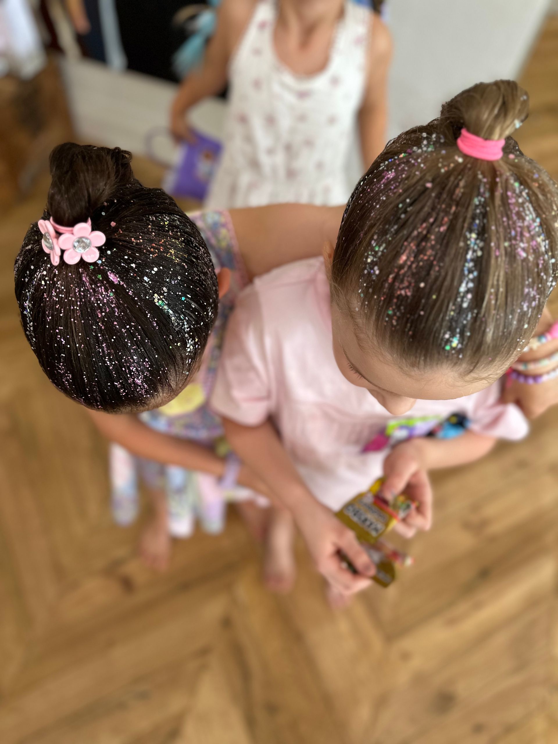 Two children with glitter in their hair in a classroom, viewed from above β Sweet Parties & Braids in Tatton, NSW