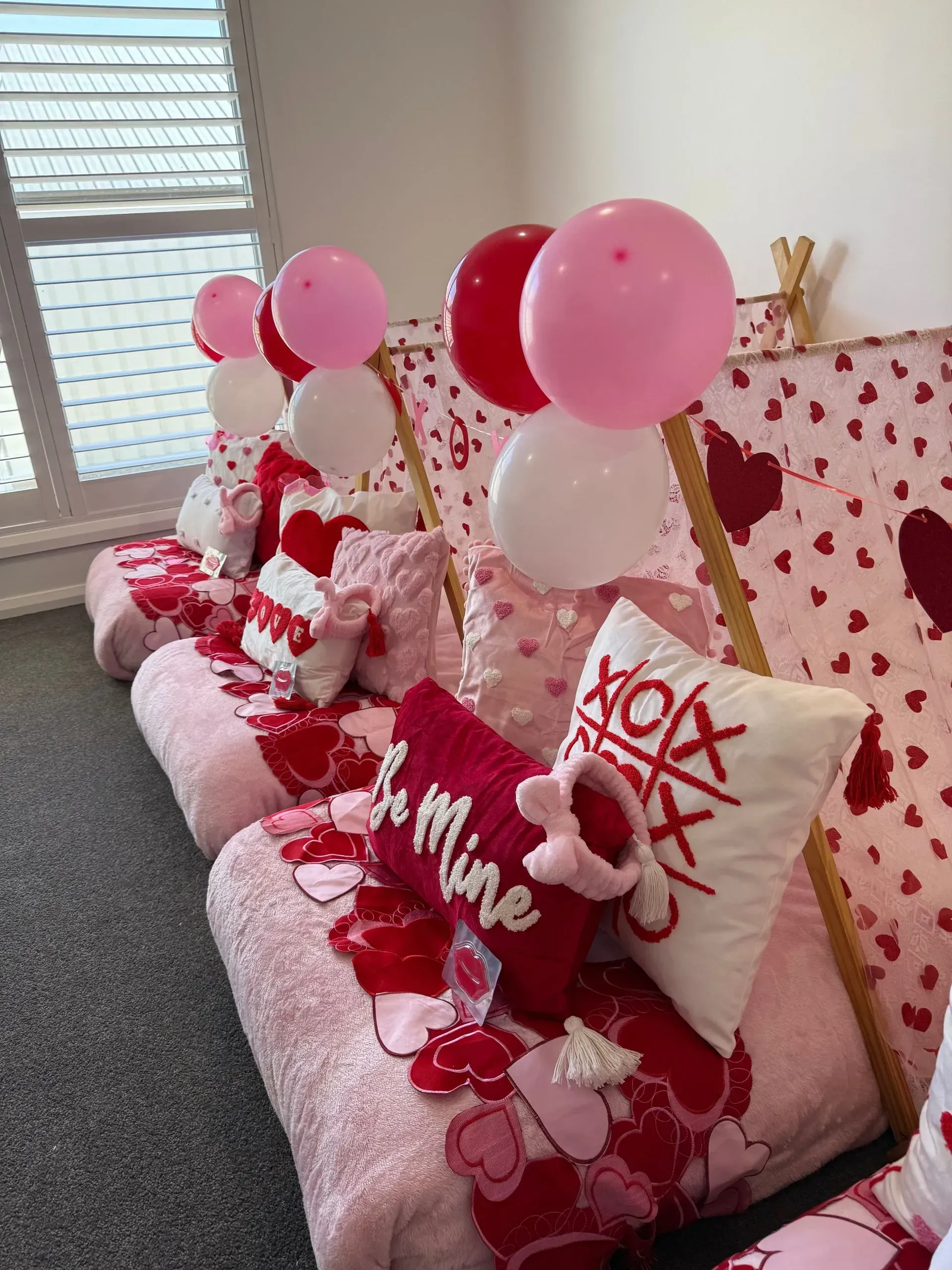 Valentine-themed Pink Couch With Heart Pillows and Red-pink Balloons — Sweet Parties & Braids in Tatton, NSW