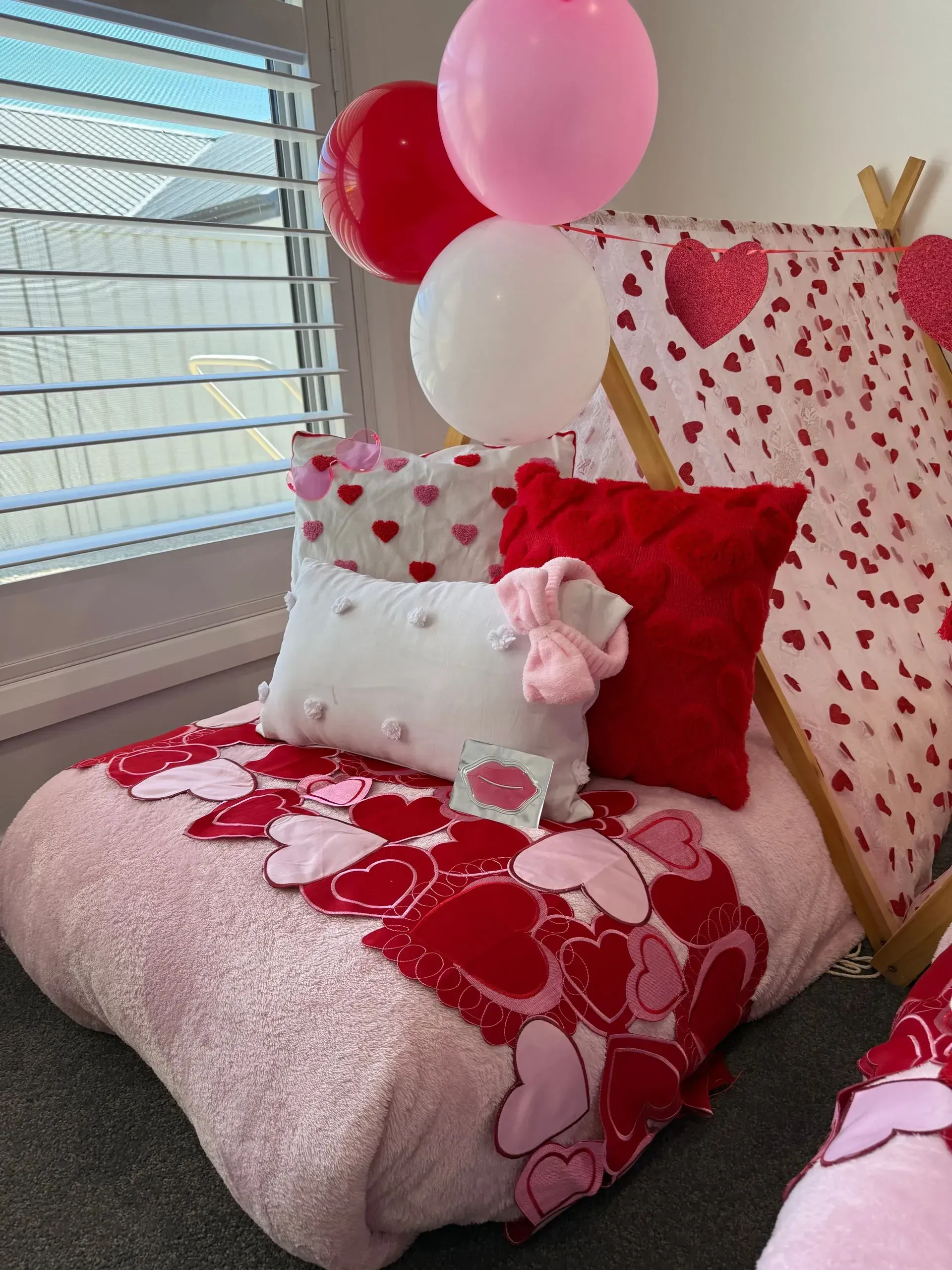 Pink Heart-themed Bed With Red, White, and Pink Balloons — Sweet Parties & Braids in Tatton, NSW