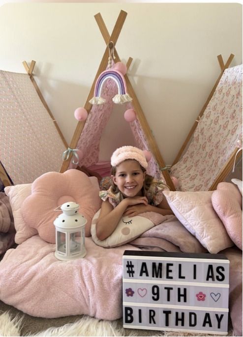 Girl Smiling in a Pink Teepee Bed With Pillows — Sweet Parties & Braids in Tatton, NSW