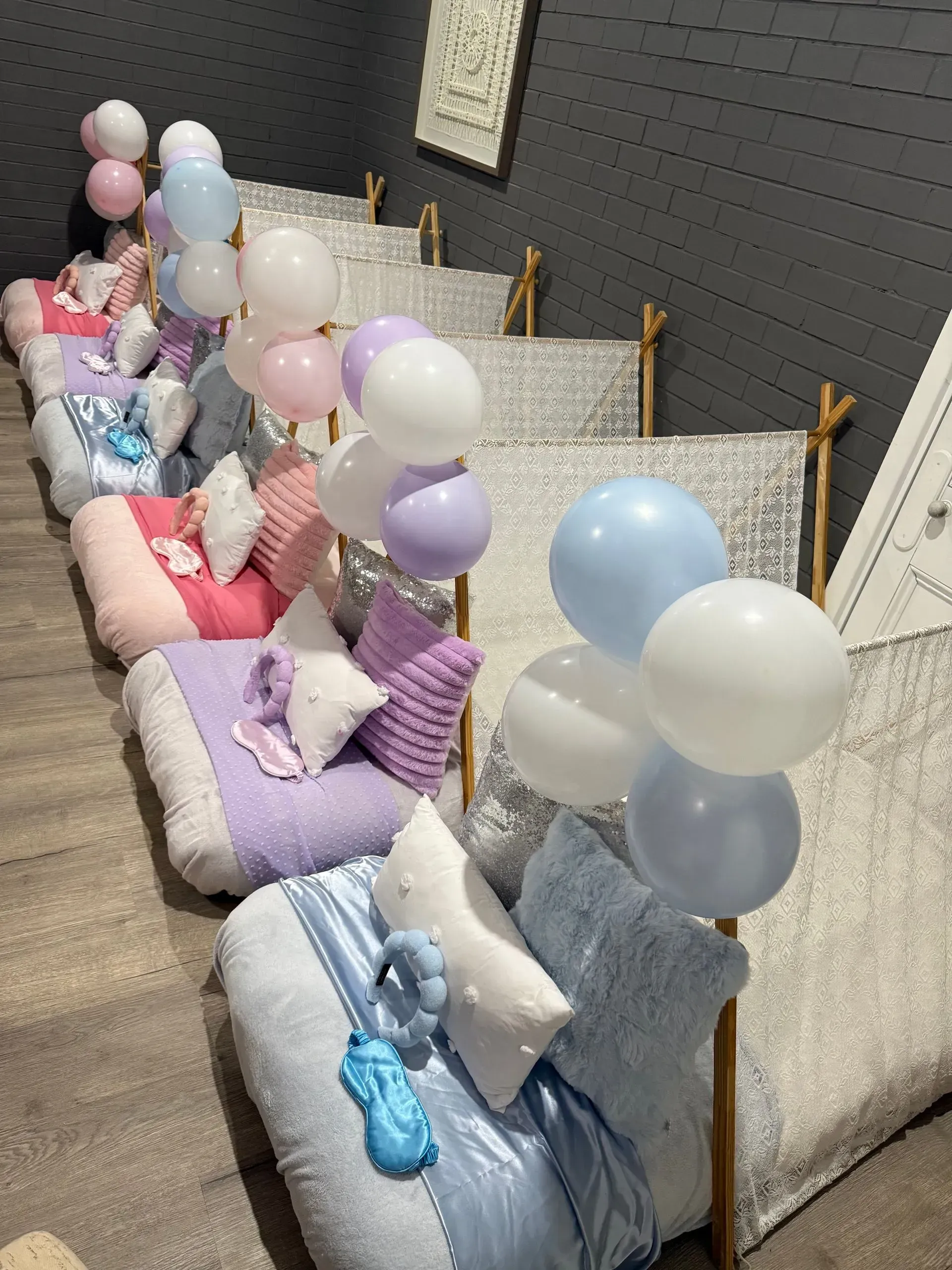 Rows of Colorful Balloon-decorated Floor Cushions Along a Gray Wall — Sweet Parties & Braids in Tatton, NSW