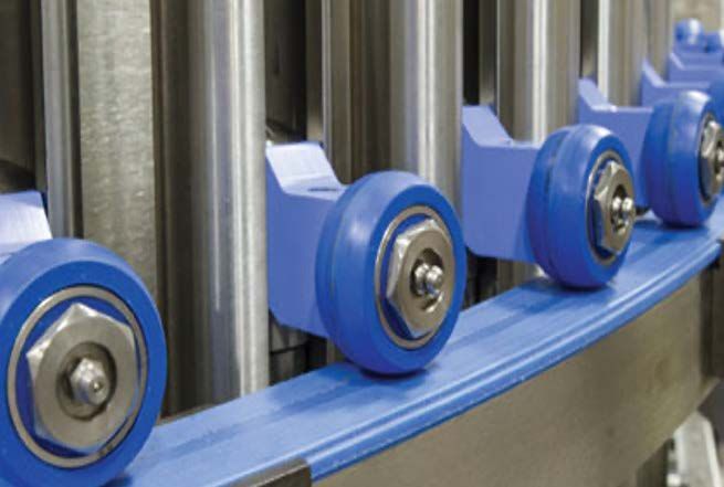 A close up of a conveyor belt with blue wheels on it.