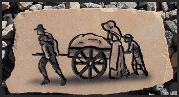 Black metal silhouette of people pulling a wagon, mounted on a stone plaque outdoors.