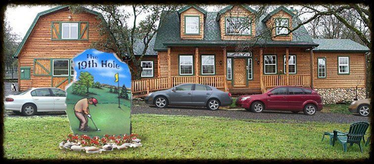 Front of a brick house with painted lawn art and a parked silver car and red SUV