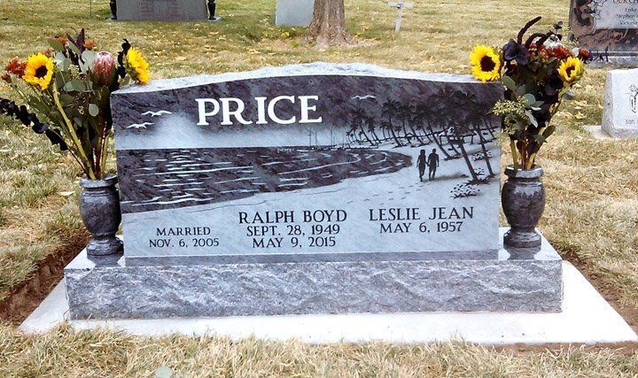 Price family gravestone with sunflower bouquets in a cemetery, engraved in gray stone.