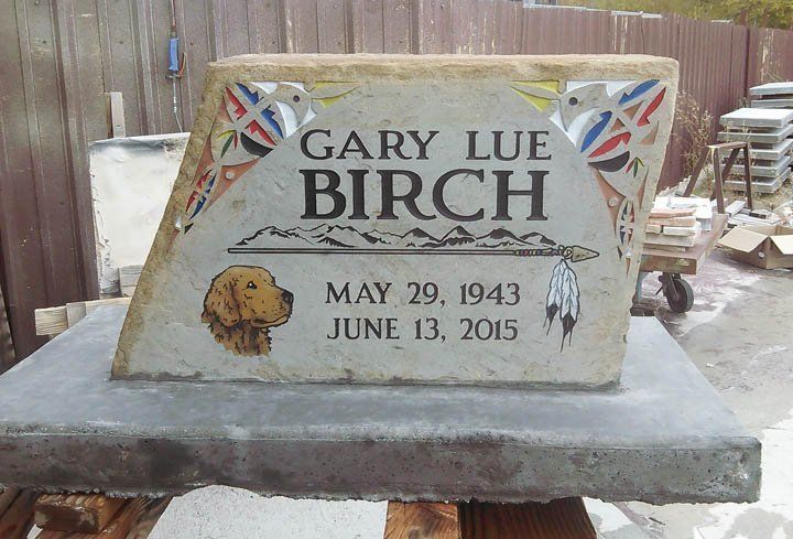 Birch memorial bench engraved “Gary Lue Birch” with dates, set outdoors on a concrete base