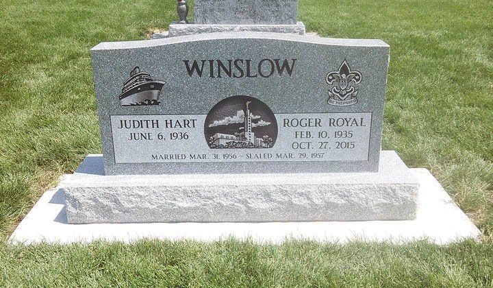 Gray granite gravestone in grass, engraved “WINSLOW,” with two inset portrait plaques.