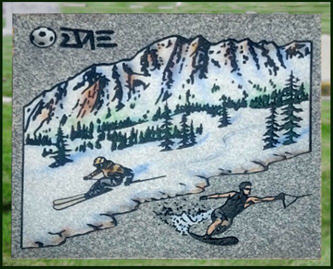 Snowboarders on a snowy mountain slope with pine trees and rocky peaks in the background.