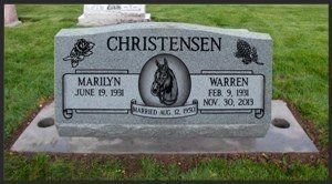 Christensen family gravestone with engraved portrait in a grassy cemetery