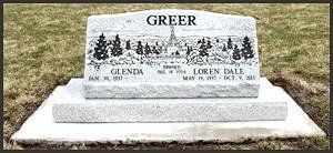 Greer family gravestone in a cemetery, with engraved trees and names on a light stone monument