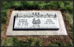 Gravestone marker for the Lee family on a grassy lawn, with engraved names and dates.