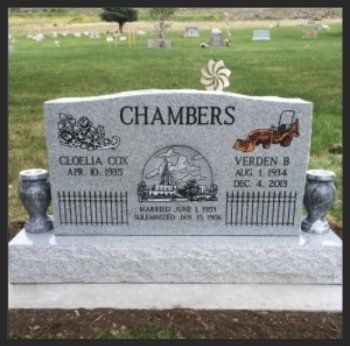 Chambers family gravestone in a cemetery, gray stone with engraved names and decorative vases.