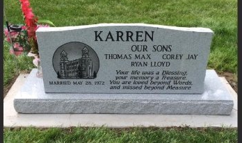 Gray granite memorial headstone for the Karren family in a grassy cemetery.