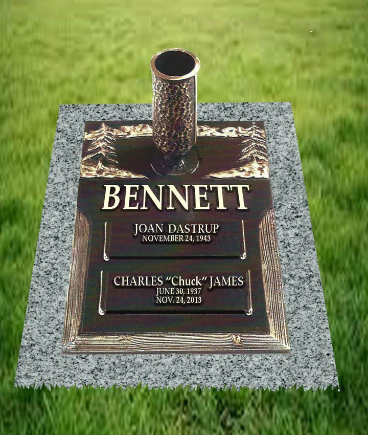 Bennett family gravestone with bronze plaque and a flower vase on a grassy lawn