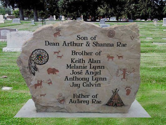 Memorial gravestone with engraved names and emblems in a cemetery