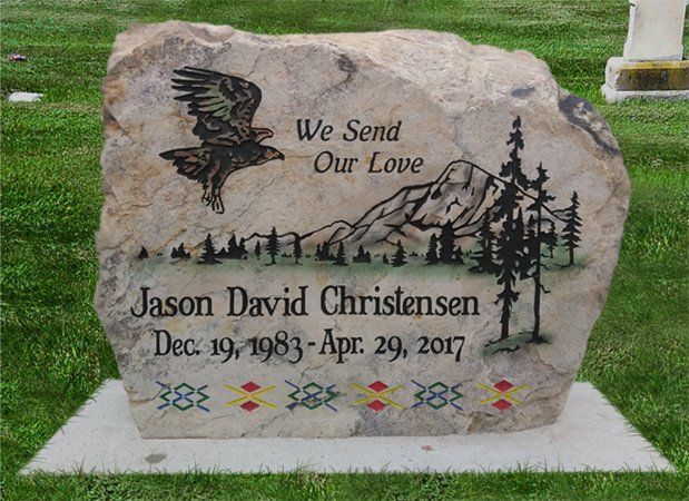 Memorial gravestone engraved “We Send Our Love” for Jason David Christensen with dates and mountain scene