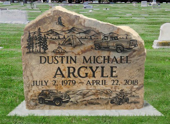 Gravestone for Dustin Michael Argyle with mountain, pine tree, and jeep engravings in a cemetery